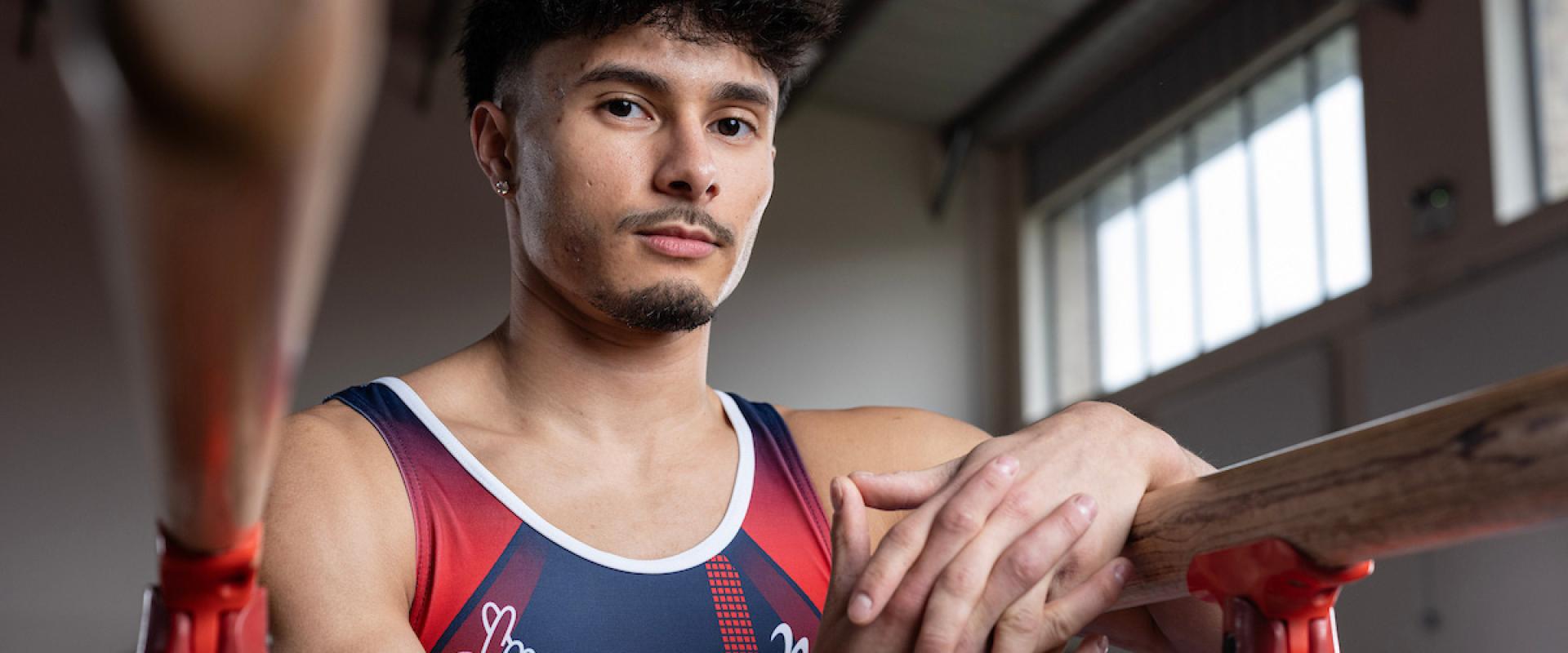 Gymnast Jake Jarman poses by the parallel bars